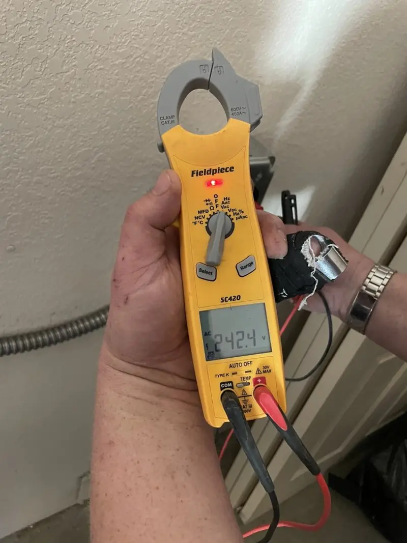 Voltage testing with clamp meter during Whole House Surge Protector in Schaumburg
